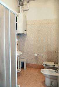 a bathroom with a toilet and a sink at Isola di Pasqua in Caorle +28 photos