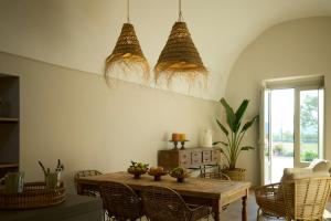a dining room with a wooden table and chairs at Tenuta Giotta in Castellana Grotte