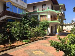 a house with a pathway in front of it at RAMRA Homestay Madikeri in Madikeri