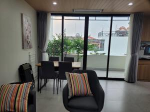 a living room with a table and chairs and a large window at The Delice house near Train street, old Quarter in Hanoi