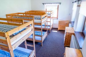 a room with four bunk beds and a window at Domček Horskej Služby in Liptovská Sielnica