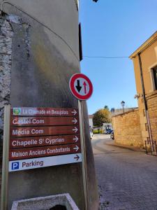 a sign on a pole next to a street at La Chamade en Beaujolais in Anse