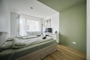 Postel nebo postele na pokoji v ubytování GoldenHugo rooms