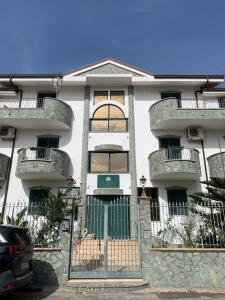 an apartment building with balconies and a gate at Don Michele Apartments in Gizzeria