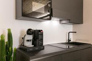 a kitchen with a sink and a coffee machine on a counter at Le Fantine Rooms in Campomarino