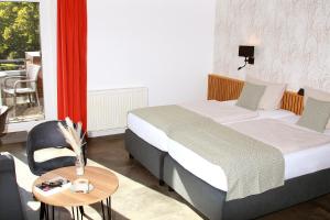 Postel nebo postele na pokoji v ubytování Hotel Quellenhof