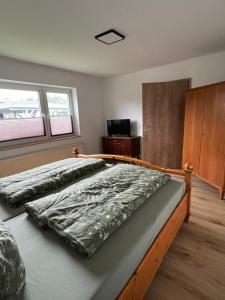 Postel nebo postele na pokoji v ubytování Ferienhaus unterm Kohnstein