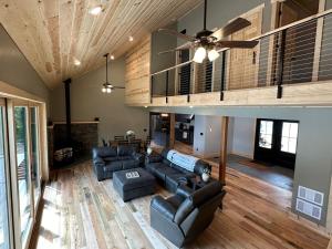 a living room with couches and a ceiling fan at Pleasant Lake Bed and Breakfast in Osceola