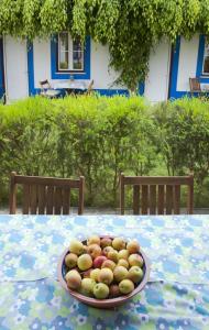 a bowl of fruit sitting on a table at CASAZUL Milfontes in Vila Nova de Milfontes