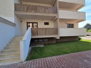 a house with a staircase in front of it at Apartament zona ISU Bistrita in Bistriţa
