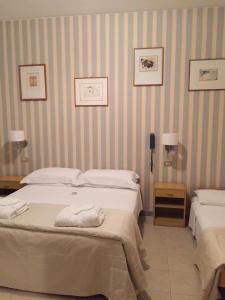 Postel nebo postele na pokoji v ubytování Hotel Ariella