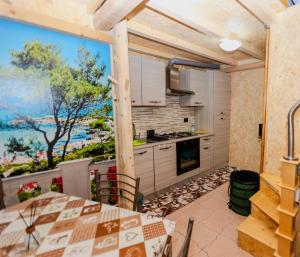 a kitchen with a table and a large window at Mini casa a 30 mt dalla spiaggia in Catania +19 photos