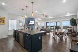 a kitchen and living room with a dining room at Breathtaking Lake Views-Dog Friendly-$400 of Free Tickets-High End Decor in Branson