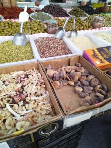 a market with many boxes of different types of nuts at macchia mediterranea in Castellammare del Golfo