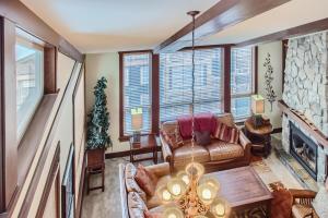 a living room with a couch and a fireplace at Stonegate Resort Unit A401 in Big White
