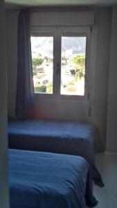 A bed or beds in a room at Marenia, dúplex en primera línea de playa