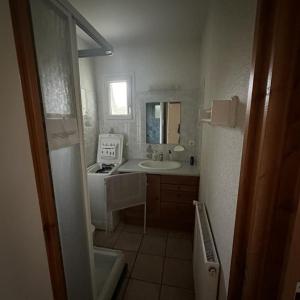 a white bathroom with a sink and a stove at Les Gîtes du Bulhion in Molles