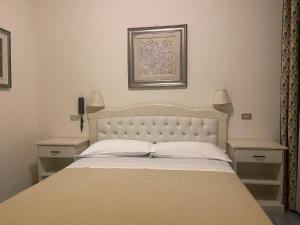Postel nebo postele na pokoji v ubytování Hotel Ariella