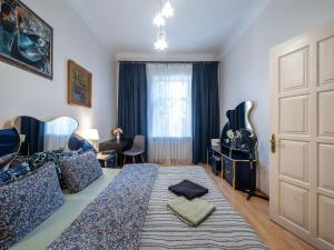 a bedroom with a large bed and a door at Alunana Premium & Fireplace apartment in Art Nouveau district, 63 sqm, 1870s, Self check-in in Rīga