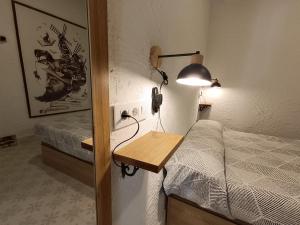 a bedroom with a bed and a desk with a lamp at Calle Yelmo de Mambrino 19 in Campo de Criptana