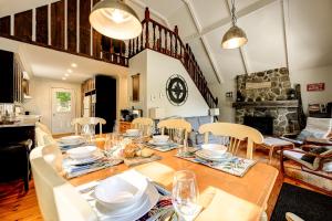 a dining room with a table with dishes on it at Chalet Douce Evasion St Adolphe in Morin Heights