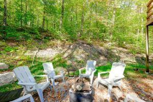 a group of white chairs sitting around a campfire at Chalet Douce Evasion St Adolphe in Morin Heights
