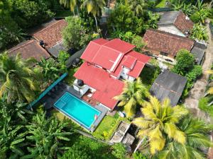 an aerial view of a house with a swimming pool and palm trees at Urban Galle Villa in Galle