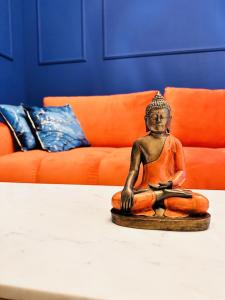 a small statue sitting on top of a table at Indigo Royale apartman Borovi in Divčibare