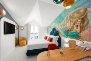 a room with a bed and a painting on the wall at Albergo Dipinto BaccoFurore in Furore