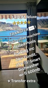 a poster of a room with a view of the ocean at DELUXE 3 Rooms74m2,2Air Condit 2TV SEAVIEW on AMADORES,2 heatPOOLs, PARKING, 600 MB,Dishwasher,2Lift,,3 BEACHes in Playa del Cura