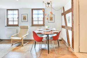 a dining room with a table and chairs at Au pied des remparts à Eguisheim in Eguisheim +24 photos