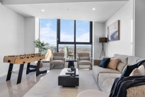 a living room with a couch and a table at The Ocean - Beachfront 72F 3Bedroom Skyhome Ocean Views with Parking & Resort Facilities in Gold Coast