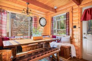 a log cabin with a table and a clock on the wall at The Lions Den in Big Bear City