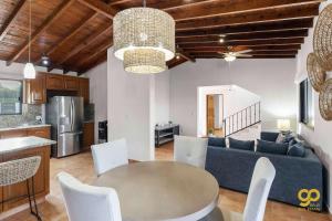 a living room with a table and a couch at El Centenario Fully-equipped Home Steps to Beach in El Centenario
