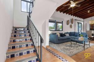 a living room with a blue couch and a table at El Centenario Fully-equipped Home Steps to Beach in El Centenario