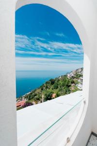 a view of the ocean from the balcony of a house at Albergo Dipinto BaccoFurore in Furore