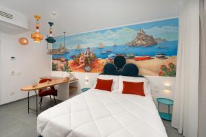 a bedroom with a white bed and a painting on the wall at Albergo Dipinto BaccoFurore in Furore