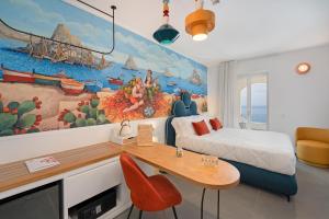 a room with a bed and a desk and a painting at Albergo Dipinto BaccoFurore in Furore