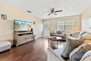 a living room with a large flat screen tv at 3BR Coastal Escape Near Beaches, Golf, Shops in North Port