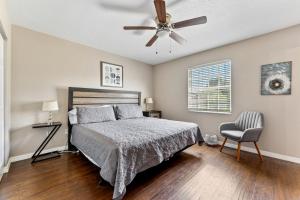 a bedroom with a bed and a ceiling fan at 3BR Coastal Escape Near Beaches, Golf, Shops in North Port