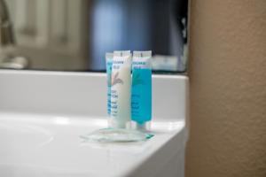 two bottles of toothpaste sitting on a bathroom counter at 3BR Coastal Escape Near Beaches, Golf, Shops in North Port +18 photos