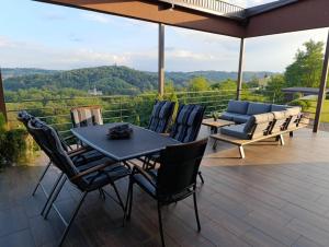 a patio with a table and chairs and a couch at HillTop House in Štrigova