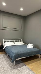 a bedroom with a bed with a blue blanket at Your comfortable home in Prigorodnyy