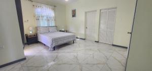 a living room with a bed and a window at Palm Breeze Villa JM in Lucea