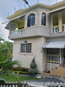 a house in the philippines with a balcony at Palm Breeze Villa JM in Lucea