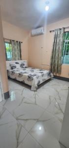 two beds in a room with marble floors at Palm Breeze Villa JM in Lucea +39 photos