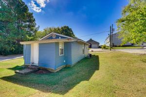 a small blue house sitting on top of a yard at Idyllic Fayetteville Home - Walk to UA Campus! in Fayetteville