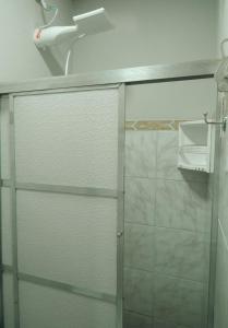 a shower with a glass door in a bathroom at Hospedagem Rancho Fundo in Diamantina