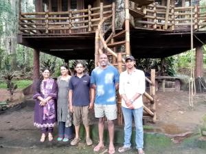 a family standing in front of a tree house at Jungle Tree House Munnar in Munnar +18 photos