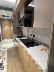 a kitchen with a sink and a counter top at Diamond in City by WOW Property in Accra